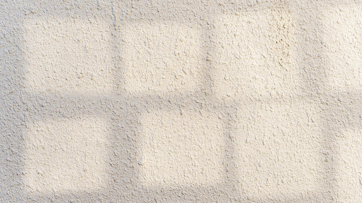 Drywall wall imperfection visible under afternoon light