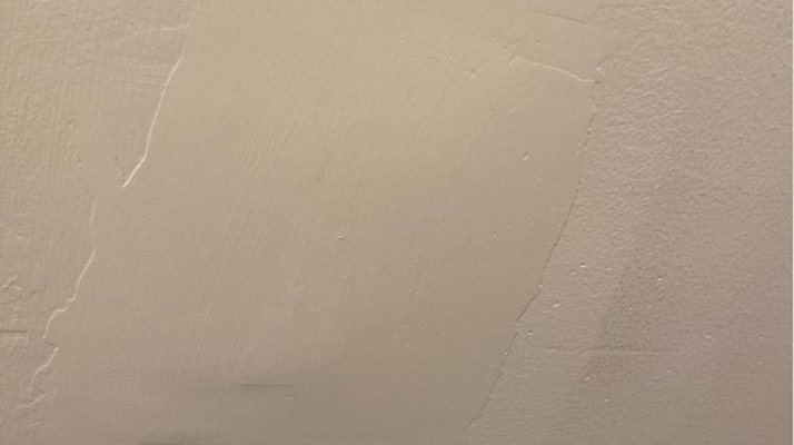 Drywall patch mismatch visible due to poor blending